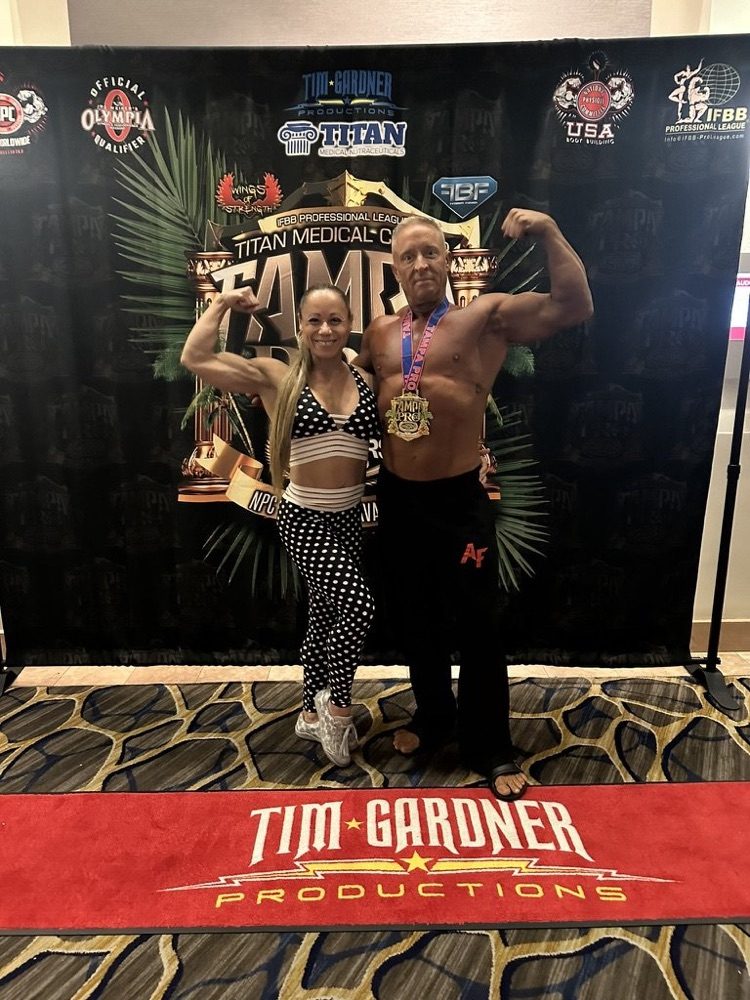 Front double biceps at the Tim Gardner backdrop